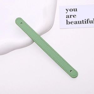 Detail of light green litchi texture PU leather wrist strap with refined stitching