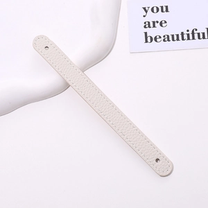Detail of cream white lychee grain PU leather wrist strap with reinforced stitching