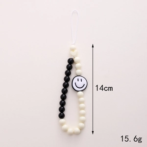 Short acrylic beaded phone strap with black and white smiley face charm, 14cm length