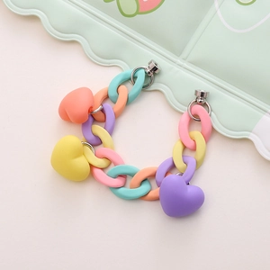 Detailed macro view of acrylic chain bracelet with matte colorful heart charms and silver clasp