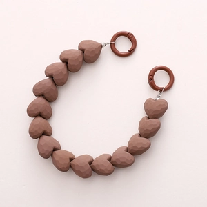 Brown heart beaded chain strap with matte geometric facets and round spring buckles