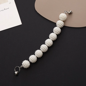 Detail of beaded pearl mobile chain with nine white spheres and silver metal clasps
