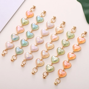 Colorful iridescent acrylic heart charm strap with macaron beads and gold clasp hardware
