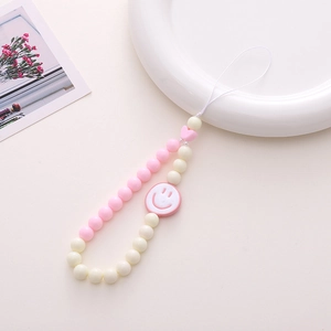 Pink and white acrylic beaded phone strap with heart and smiley face charm decoration