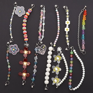 Detail view of colorful handmade beaded phone straps with smiley faces and heart charms