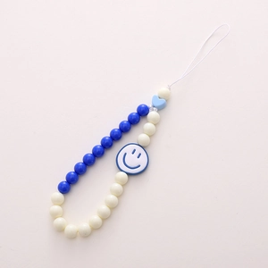 Acrylic beaded phone strap with blue smiley face and heart beads on white background