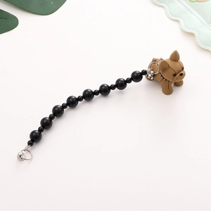 Close-up of black beaded phone strap with a matte brown French Bulldog charm and metal clasp