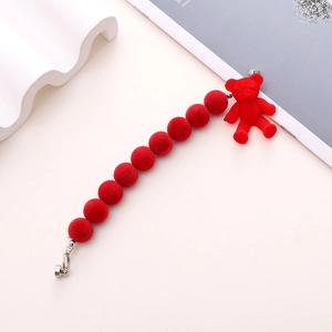 Detail of red flocked beads and bear charm for phone case jewelry making