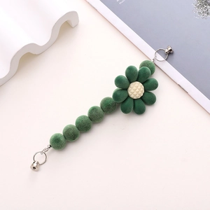 Plush floral curtain tieback with green flocked beads and magnetic metal closure