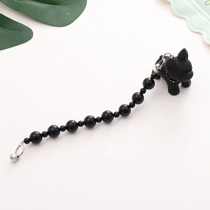 Close-up of black beaded phone strap featuring a cute French Bulldog charm and metal clasp