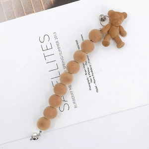 Detail of brown flocked teddy bear charm and soft beaded chain with silver metal clasps