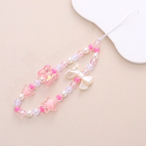 Detailed view of pink and white beaded phone strap with acrylic bow and star charms