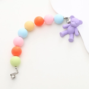 Detail of colorful matte acrylic beaded phone strap featuring a cute lavender bear charm