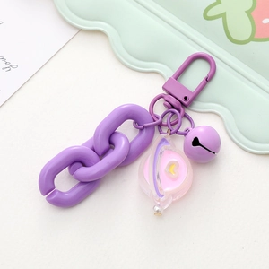 Detail of purple cartoon keychain with spring buckle, chain, bell and heart charm