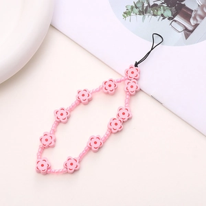 Detail of pink floral beaded phone strap with handmade wooden flower beads and wrist loop