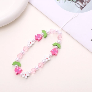 Detailed view of handmade pink wooden tulip and pearl beaded wrist strap for phone case