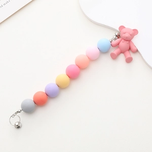 Detail of macaron matte acrylic beads and pink bear charm for phone cases