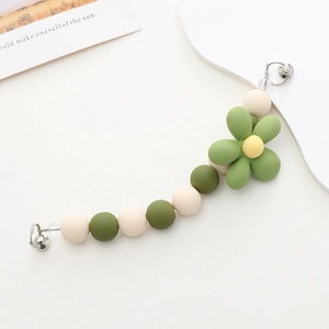 Frosted acrylic beaded phone strap with a green flower charm and metal clasp