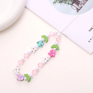 Close-up of wooden tulip beads and pearls on a colorful beaded phone strap