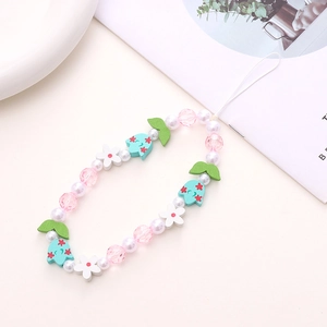 Detailed macro shot of floral wooden beads with imitation pearls on a short phone wrist strap