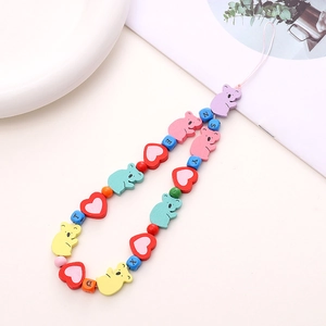 Macro shot of wooden flower beads and colorful letter blocks on a phone wrist strap