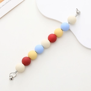 Macro detail of matte acrylic beaded phone strap with durable silver metal buckles