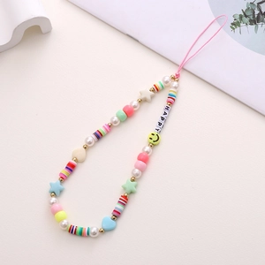 Detail of handmade beaded phone strap with colorful clay discs and HAPPY letter beads