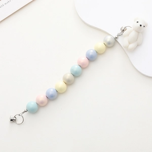Close-up of pastel matte acrylic beads and a white flocked bear charm phone lanyard
