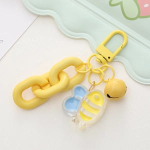Detail of yellow bee keychain with acrylic pendant, plastic chain and lobster clasp