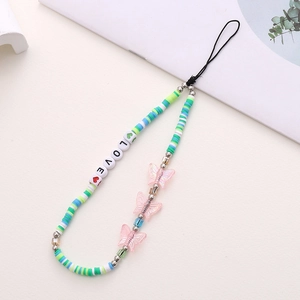 Detail of DIY clay evil eye phone charm with LOVE letter beads and butterfly pendant