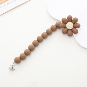 Detail view of matte mocha silicone beads and daisy clip for baby pacifier chain