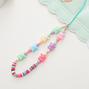 Detailed shot of colorful acrylic bear beads and pearl charms on a phone wrist strap