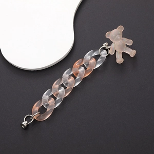 Detailed macro of pink gradient acrylic phone chain with frosted bear charm and metal clasp