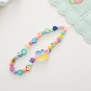Detail of beaded phone strap featuring acrylic bee charm, fruit beads and smile faces