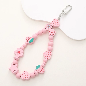Pink wooden bead charm featuring hand-painted strawberry heart and floral shapes