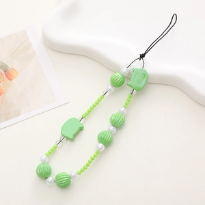 Detail of green and pearl white beaded phone wrist strap with cute animal charms
