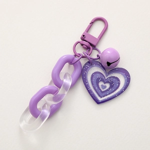 Portachiavi a cuore in acrilico viola con campanellino e chiusura a moschettone su fondo
