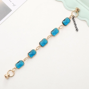 Detail of dark blue crystal rectangular link chain with golden magnetic clasp and extension