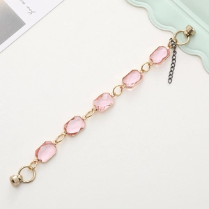 Detail of pink crystal glass bracelet with gold metal frame and magnetic clasp closure