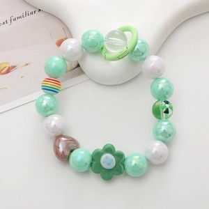 Detail of mint green beaded phone strap with iridescent beads and flower charm