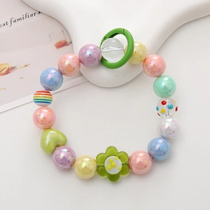 Close-up of Y2K style handmade beaded phone strap with colorful acrylic heart and flower beads