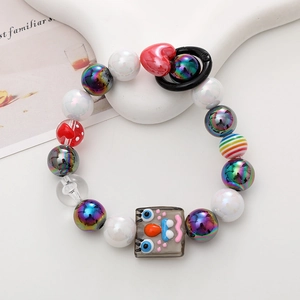 Close-up of colorful handmade beaded phone strap with a cute cartoon face charm