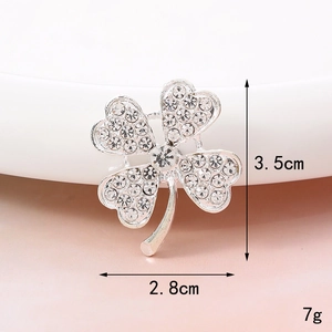 Detailed view of silver clover brooch with rhinestones showing dimensions 3.5cm by 2.8cm