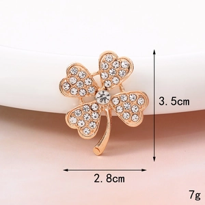 Macro shot of rose gold clover brooch with pave zircons showing 3.5cm height