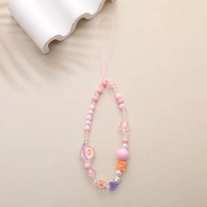 Detail of pink beaded phone strap featuring cute cartoon bear and heart charms