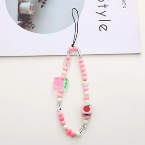 Detail showing pink and white beaded phone strap with cute bear and heart charms