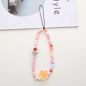 Detailed macro view of colorful acrylic beads and alphabet cubes on a phone strap charm