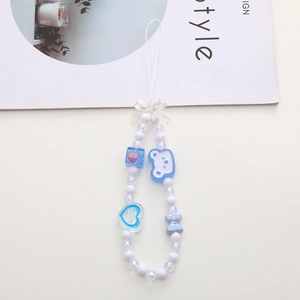 Detailed view of light blue beaded phone charm with resin bear and strawberry charms