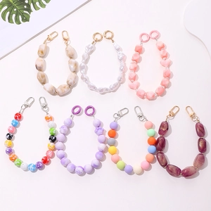 Flat lay of colorful acrylic beaded charms with marble, pearl, and heart designs