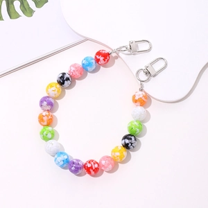 Detailed view of colorful beaded phone strap with acrylic stones and silver metal clasps